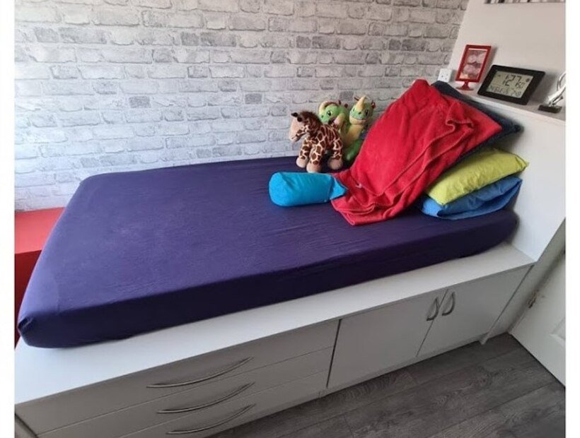 Bespoke bed and storage built over a stair bulkhead in a box room