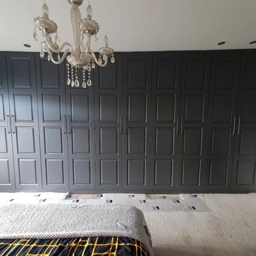 Black shaker fitted wardrobes in a bedroom