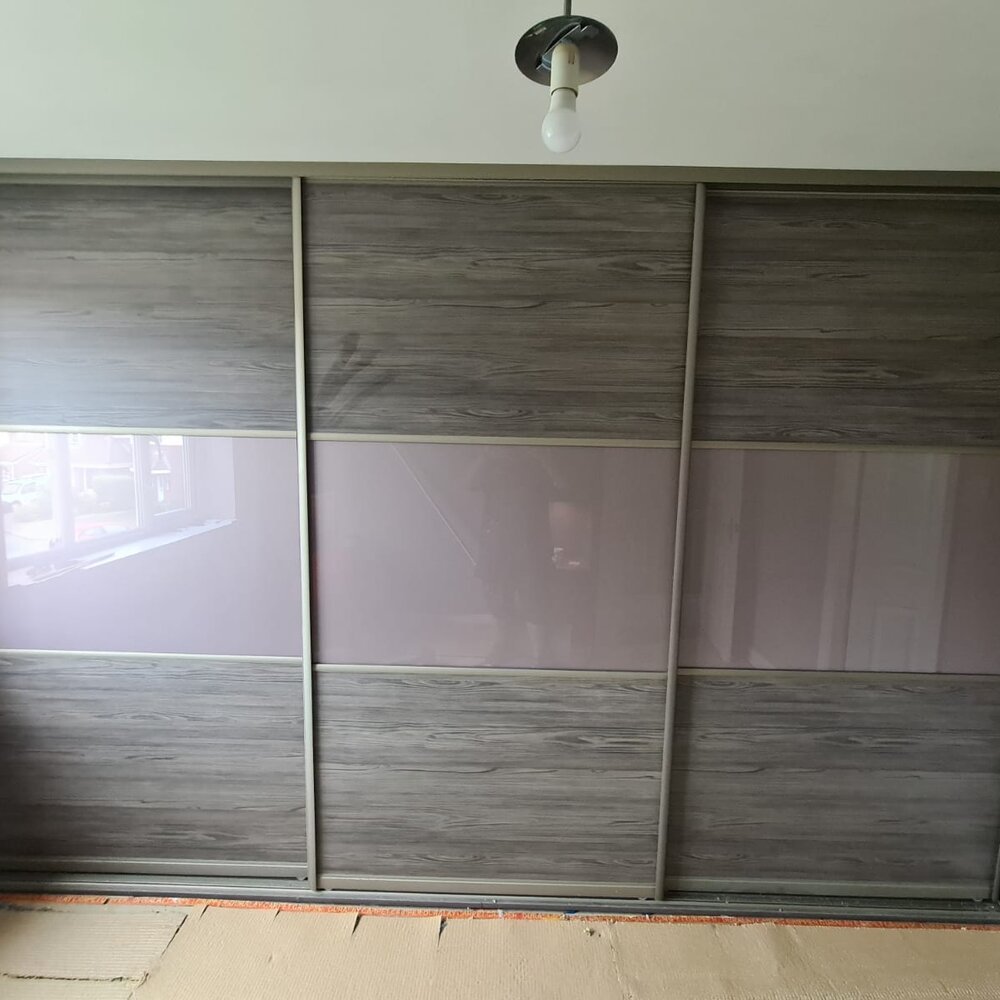 Sliding-door fitted wardrobes in a Cheshire bedroom