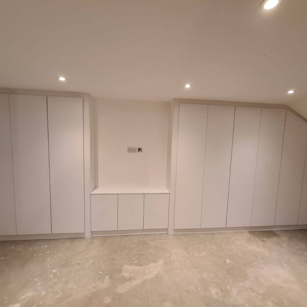 White fitted wardrobes in a bright bedroom