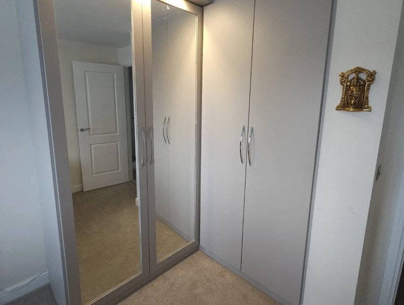 Sliding mirrored-door fitted wardrobes in a Cheshire bedroom