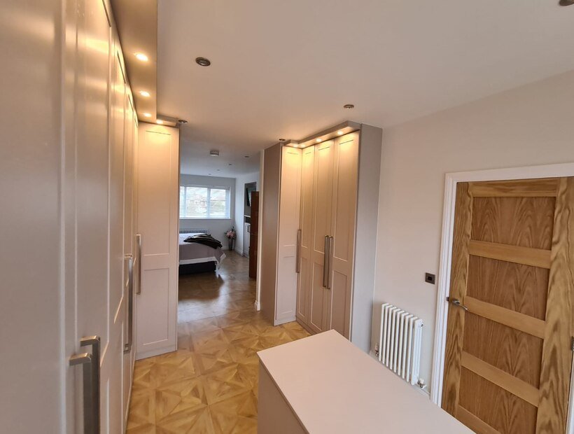 Fitted wardrobes and storage lining a small box bedroom in Warrington
