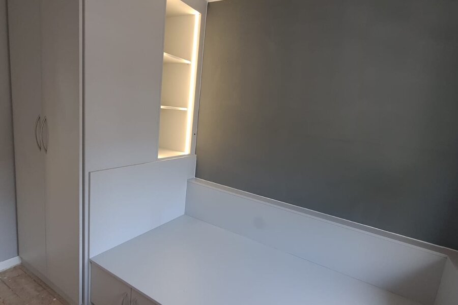 Fitted storage built over a stair bulkhead in a stairbox box room in Warrington