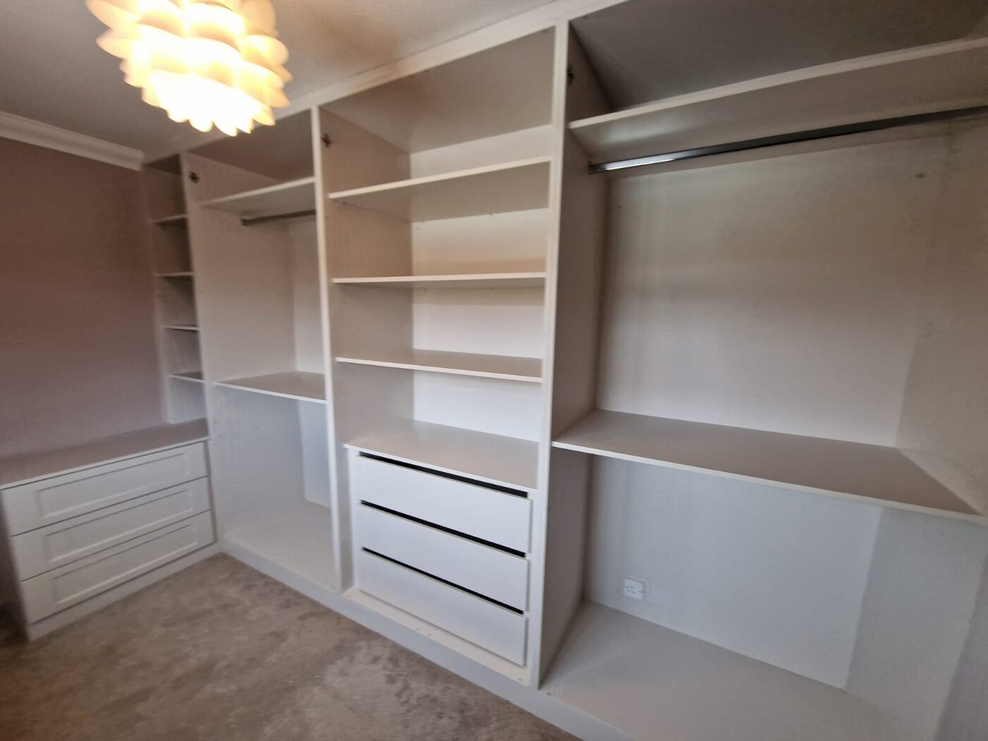 Walk-in wardrobe dressing room with open shelving and drawers in Warrington