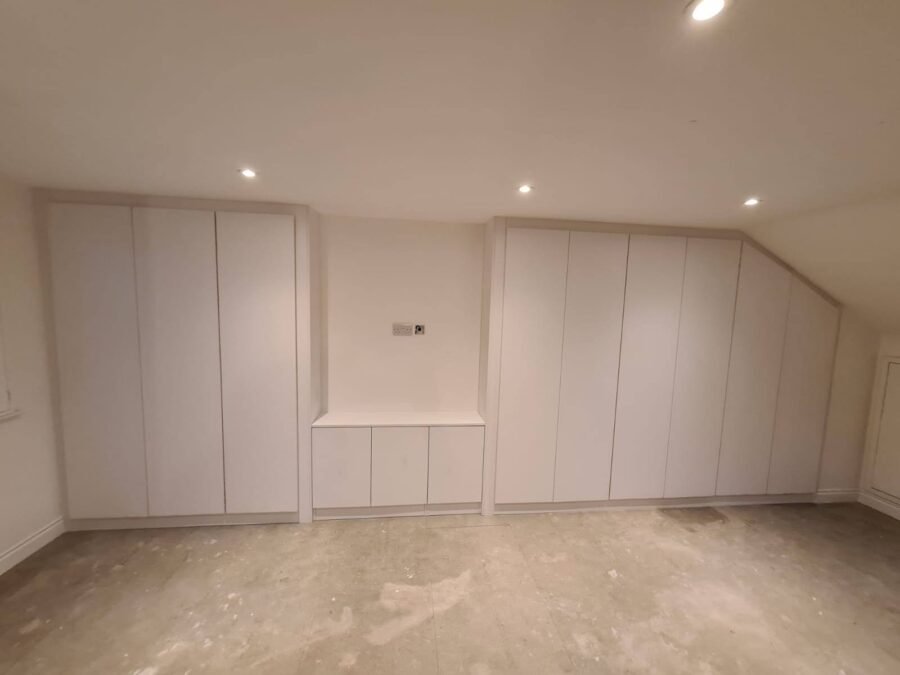 A project photo of wardrobes installed under a sloping ceiling in a loft conversion with low eaves